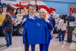 Congresswoman Mary Gay Scanlon (PA-02) and Congressman Brendan Boyle (PA-05) hold a Nuns on the Bus t-shirt after making a call to vote to all gathered at Love Park in Philadelphia, PA