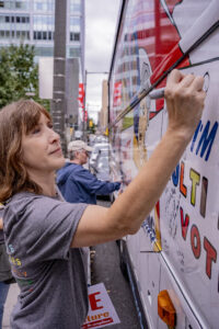 Sister Quincy Howard, OP, signs the bus after the rally.