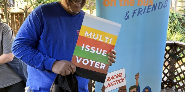 NETWORK Fellow Ralph McCloud shows his support for multi-issue voting during the press conference following the site visit to Mission Action in San Francisco on the final day of the Nuns on the Bus & Friends "Vote Our Future" tour, Oct. 18.